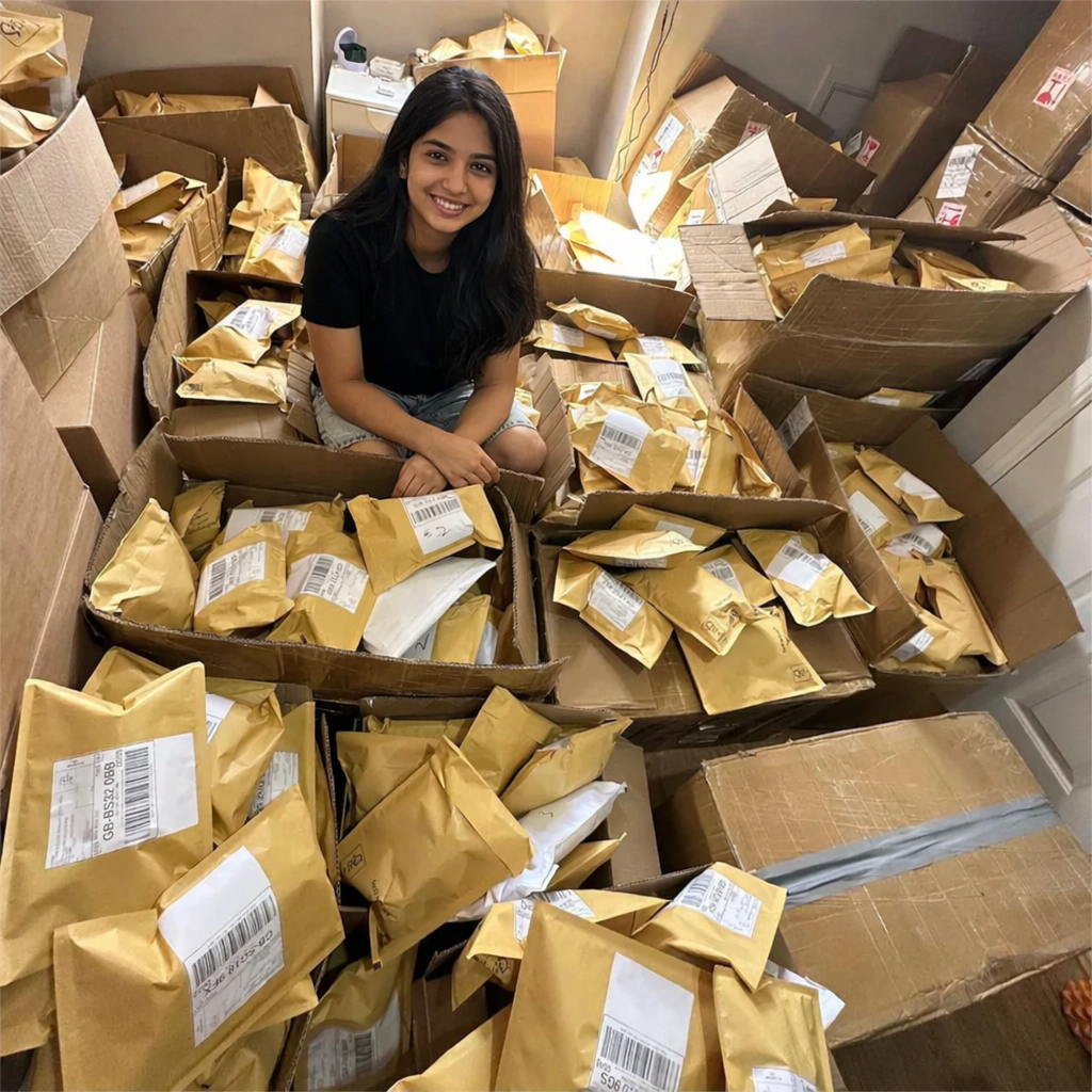 Woman sitting amidst a large number of包裹 and boxes