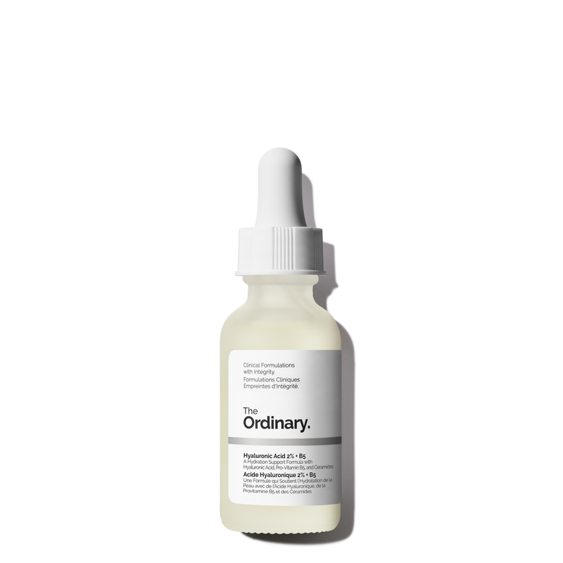 A white dropper bottle of The Ordinary Hyaluronic Acid 2% + B5 serum stands upright on a white background with a right-hand shadow. Its black and gray label is visible. Perfect to pair with the Hydrocolloid Breakout Recovery Mask for targeted acne care.